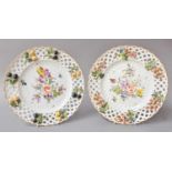 A Pair of German Porcelain Plates in the Meissen Style, with pierced borders applied with fruit