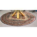 An Indian Roundal Carpet, the indigo ivory and maroon cusped field of floral design enclosed by