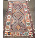 A Gendje Rug, with a polychrome field of serrated rhombi and diamond medallions, enclosed by a