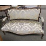 An Edwardian Carved Mahogany Two-Seater Sofa, with part upholstered open arms and leaf-carved