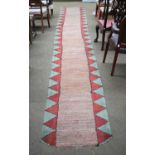 A 20th Century European Rag Rug, runner 6m in length (unfinished ends)