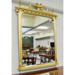 A Gilt Overmantel Mirror, the frame surmounted by thistles and a bird, 104cm by 136cm
