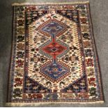 A Hamadan Rug, the plain strawberry field centered by a medallion framed by spandrels and ivory