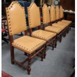 A Set of Six Modern Oak Dining Chairs, with studded leather seats and back rests, on turned