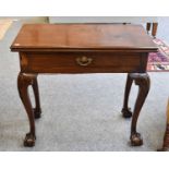 A George II Mahogany Fold Over Tea Table, with single drawer and on cabriole supports, carved with