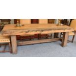 A Substantial Oak Rustic Dining Table, the two plank top raised on massive square section supports