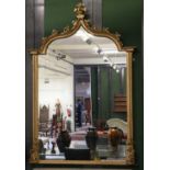 A Large 19th Century Style Gilt Framed Hall Mirror, the arched top mounted with leaves supported