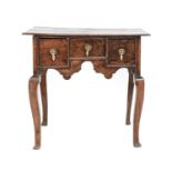 An Early 18th Century Oak Dressing Table, the moulded top above three oak-lined drawers and an