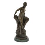 After Ferdinand Lepcke (1866-1909): A Bronze Figure of a Bather, loosely draped sitting on a rocky