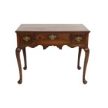 A Oak Side Table, circa 1740, the moulded top above three frieze drawers and a wavy shaped apron, on