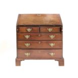 A George III Mahogany Bureau, 3rd quarter 18th century, the fall front enclosing seven small drawers