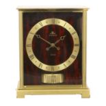 An Atmos Clock, signed Jaeger LeCoultre, model: Embassy, 20th Century, red faux marble side