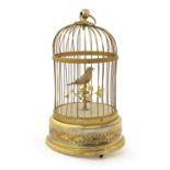 A French Gilt Metal Singing Bird Cage, early 20th century, of domed wirework form, enclosing a