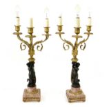 A Pair of Gilt and Patinated Bronze Three-Light Candelabra, in Louis XV style, with urn scones on