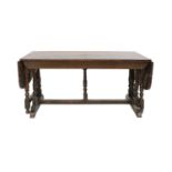 A Joined Oak Dining Table, early 18th century, of unusual form, the plank top with cleated ends