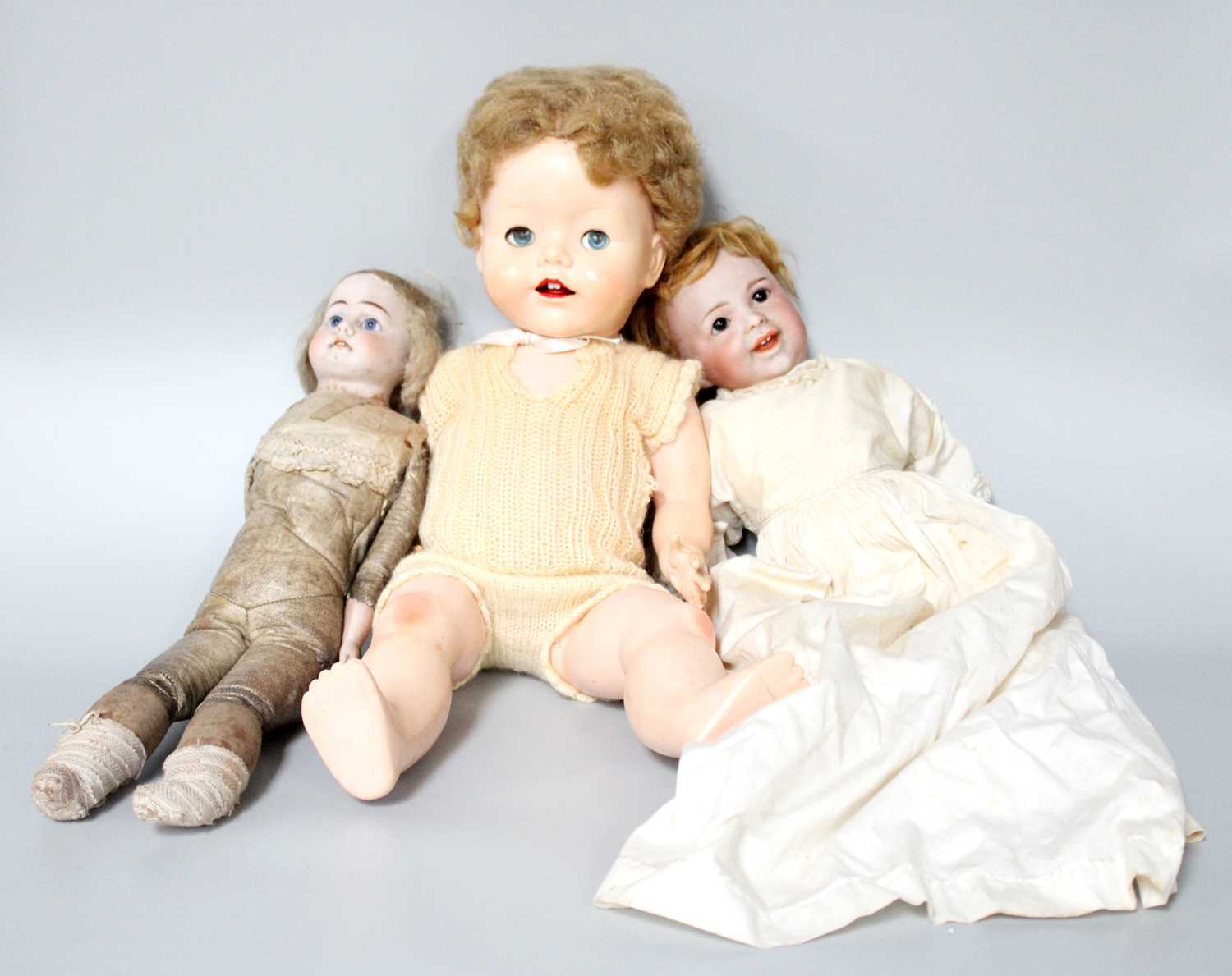 A Small German Bisque Head Doll, 19th century, another French example, and a 1960s doll (3)