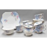 A Shelley Tea Service, comprising two cake plates, a milk jug, and sugar bowl, eleven cups, twelve