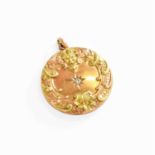 A Diamond Locket, the central old cut diamond in a yellow star setting, to an embossed border,