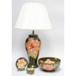 A Walter Moorcroft Coral Hibiscus Pattern Lamp, on green ground, impressed marks, 33cm high (