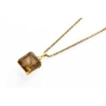 An 18 Carat Gold Smoky Quartz Pendant on Chain, the emerald-cut smoky quartz in a yellow claw