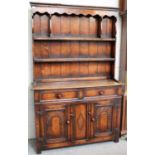 An Oak Titchmarsh & Goodwin Style Dresser of small proportions, 107cm by 33cm by 167cm