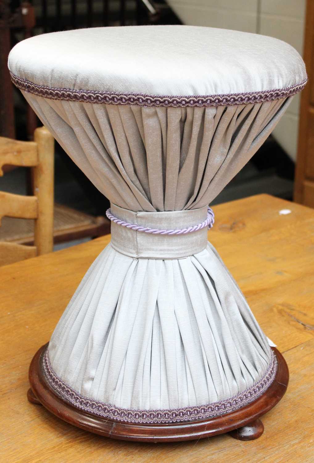 A Victorian Dressing Stool, with pleated silver upholstery and on mahogany base