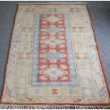 A Melas Rug, the pale terracotta field with a column of medallions enclosed by pale lemon borders,