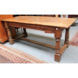 An Oak Plank Top Refectory Table, with turned supports and H stretcher, 182cm by 77cm by 73cm