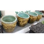 A Set of Four Chinese Earthenware Planters, slip decorated with dragons on olive grounds, 44cm