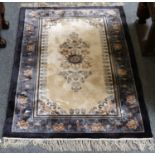 A Chinese Silk Rug, the ivory field with central floral medallion enclosed by pale indigo floral