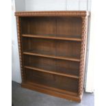 An Oak Open Bookcase, with acanthus carved frieze and barley twist supports, 120cm by 33cm by 146cm