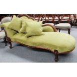 A Victorian Carved Walnut Chaise Lounge, on carved cabriole supports, later upholsterd in bright