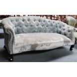A Button Back Sofa, in Victorian style, upholstered in silver velvet, with brass studs and carved