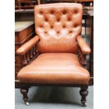 A Victorian Button Back Leather Library Chair, on mahogany frame on brass and pot castors