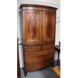 A Mahogany Bow Front Linen Press, early 19th century, with strung inlay and on bracket supports,