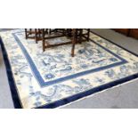 A Chinese Carpet, the ivory field centered by three lotus flowers surrounded by dragons and fo