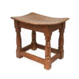 Robert Mouseman Thompson (1876-1955): A Burr Oak Dish Top Stool, with nailed top, on four