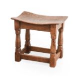 Robert Mouseman Thompson (1876-1955): A Burr Oak Dish Top Stool, with nailed top, on four