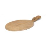 Workshop of Robert Mouseman Thompson (Kilburn): An English Oak Cheese Board, post 1960, of