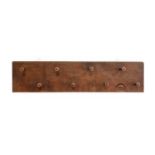 Robert Mouseman Thompson (1876-1955): An English Oak Coat Rack, rectangular back, with eight pegs,