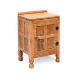Robert Mouseman Thompson (1876-1955): An English Oak Bedside Cupboard, with raised upstand, above