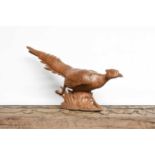 Workshop of Robert Mouseman Thompson (Kilburn): A Carved English Oak Pheasant, in a running pose,