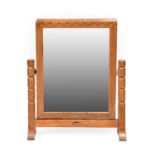 Robert Mouseman Thompson (1876-1955): An English Oak Stand Mirror, the rectangular mirror pivots