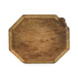 Robert Mouseman Thompson (1876-1955): An English Oak Bread Board, of canted rectangular shape,