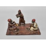 A Cold Painted Bronze Figure Group, three North African boys playing musical instruments on a