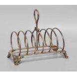 A Victorian Silver Toast-Rack, by John Gilbert and Co., Birmingham, 1879, oblong and on four