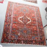 Karajah Rug, the chestnut field with three medallions, enclosed by indigo borders of stylised vines,