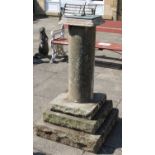 A Weathered Sandstone Sundial, the square top supported by a cylindrical column on a triple-