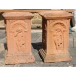 A Pair of Reconstituted Terracota Coloured Garden Pedestals Decorated with Putti