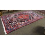 Hamadan Rug, the charcoal field with stawberry serrated medallion, framed by ivory spandrels and